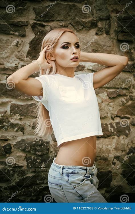 Pretty Young Fashion Sensual Woman Posing On Wall Background Dressed In