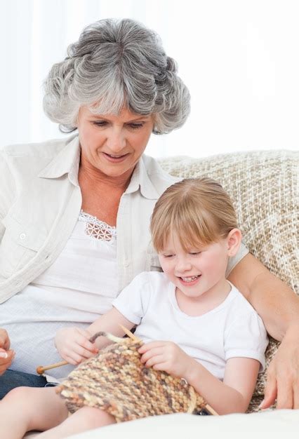 Premium Photo Grandmother Helping Her Little Girl To Knit