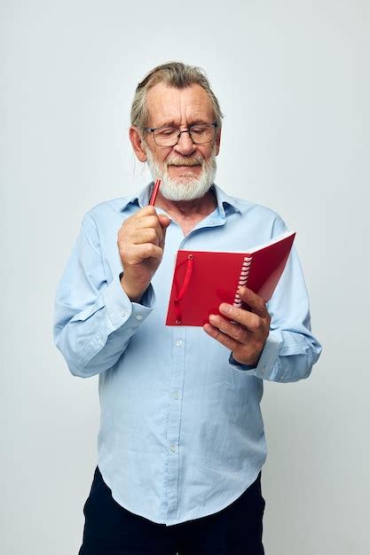 Premium Photo Senior Man Reading Book Against White Background