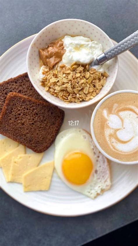 A White Plate Topped With Eggs Toast And Other Breakfast Foods Next To