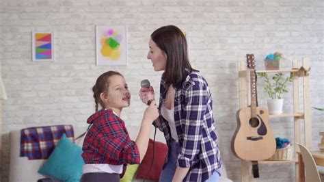 Mom And Daughter Emotionally Sing Karaoke At Home Stock Footage Video