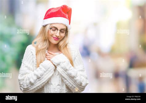 Young Beautiful Blonde Woman Wearing Christmas Hat Over Isolated