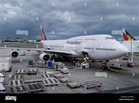 Philippine Airlines Boeing 747 being loaded with cargo containers ...