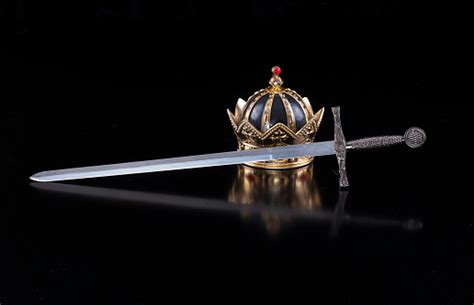 Medieval Sword And Crown On A Black Isolated Background Stock Photo