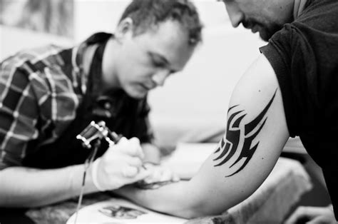 Premium Photo Tattoo Master Make Tattoo For Rocker Man