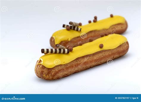 Eclair With Custard And Lemon Glaze On A White Background Confectionery For The Sweet Tooth