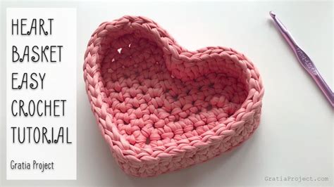 A Crocheted Heart Sitting On Top Of A Table Next To A Purple Pen