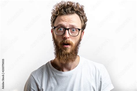 Surprised Bearded Man In Spectacles Looks With Bated Breath And