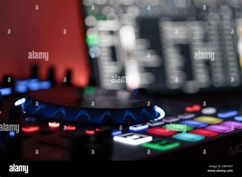 Side View Of An Dj Controller With Dj Laptop In Blurred Background