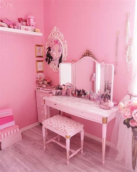 a bedroom with pink walls and furniture in the room, including a ...