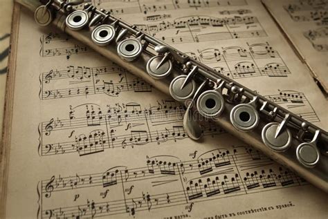 Old Silver Flute on Vintage Music Notes Stock Image - Image of ...