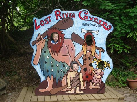 There Is A Sign That Says Lost River Cavern On It And Two People