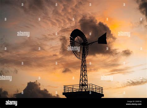 A Windmill With The Flinders Ranges Behind It During Sunrise In Besut