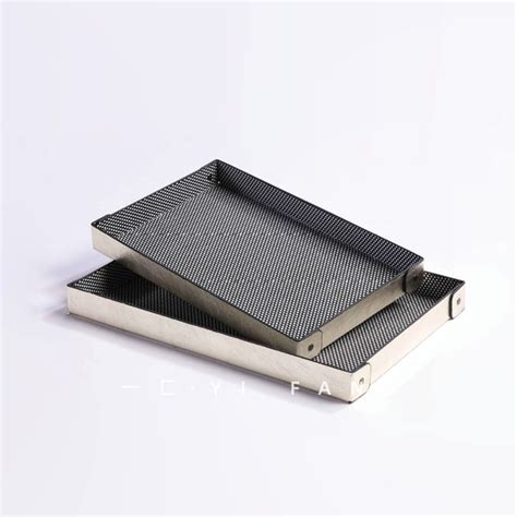 Two Metal Trays Sitting On Top Of Each Other