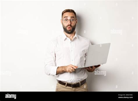 Business Surprised Business Man Holding Laptop And Looking Interested