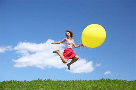 Woman Jumps Away From Grass With Large Ball Stock Photo Image Of