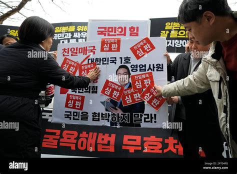 Protesters Attach Stickers On An Image Of South Korean President Yoon