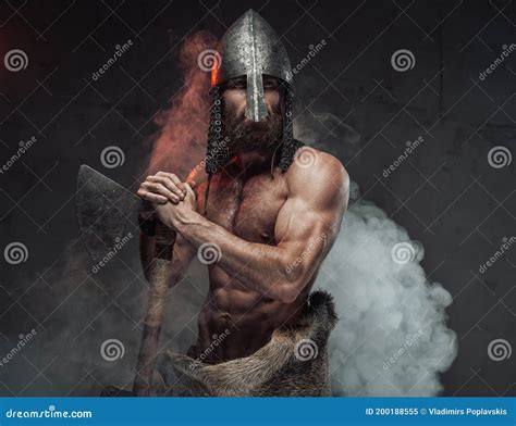 Naked Nord Warrior Posing In Dark Background With Axe Stock Photo