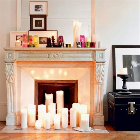 A Fireplace With Lit Candles In Front Of It