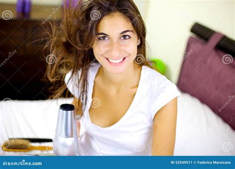 Cute Brunette Blow Drying Long Hair At Home In Bed Smiling Happy Stock