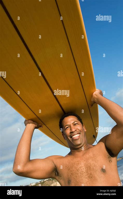 Surfer Carrying Surfboard On Head At Beach Portrait Stock Photo Alamy