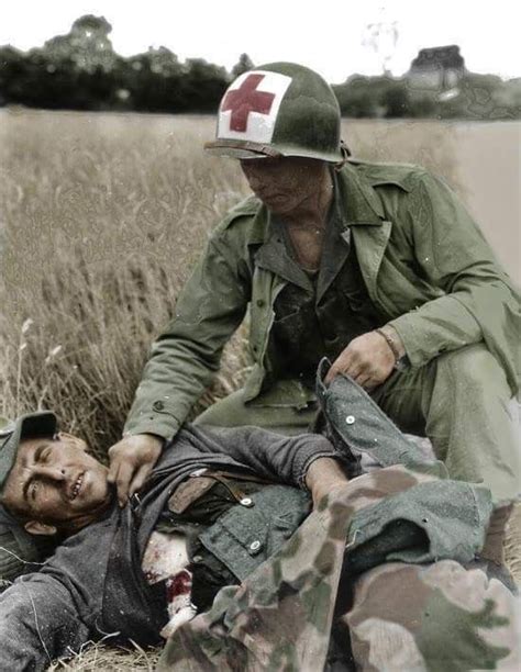 Us Medic Helps Wounded German Army Medic Wwii History Wwii