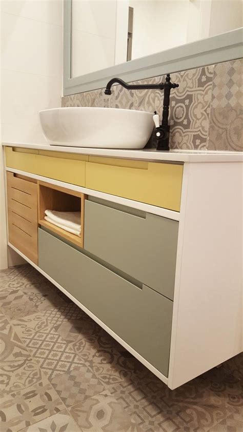 A Bathroom With A Sink Mirror And Tiled Flooring In Grey And Yellow Colors