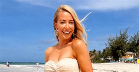 Laura Hamilton ditches her bra on the beach in plunging white dress