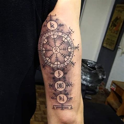 A Man S Arm With A Compass Tattoo On It And Arrows In The Middle