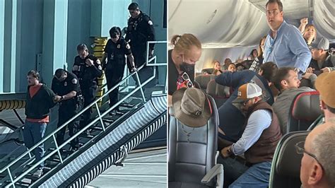 Unruly American Airlines passenger restrained by others after