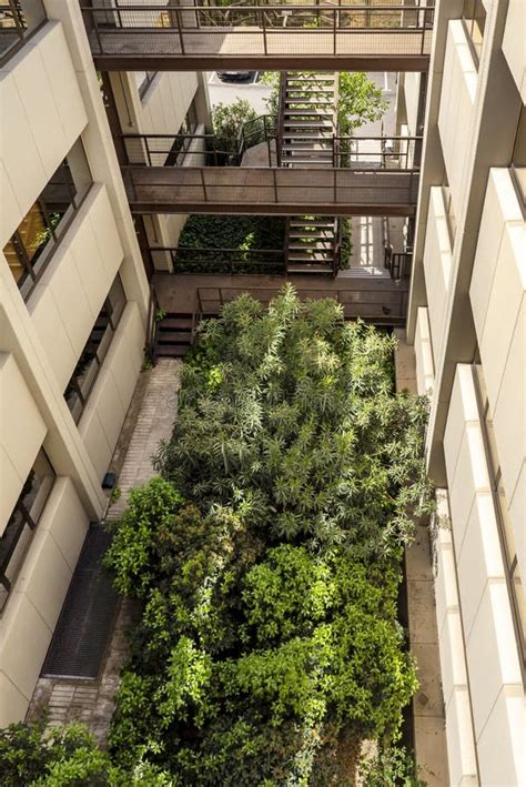 An Inner Courtyard Of An Office Building With Plants Stock Image