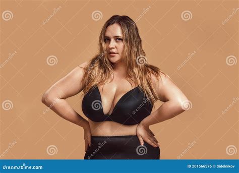 Portrait Of Plus Size Woman With Long Hair In Black Lingerie Posing In