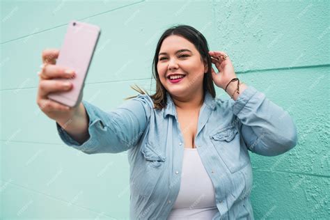 Premium Photo Portrait Of Young Plus Size Woman Taking Selfies With