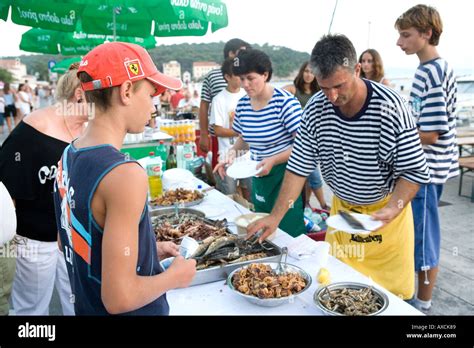 Fisherman Cooking Fish On The Quay During Ribarska Noc Fishermans Night