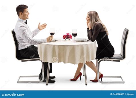 Young Man Talking To A Young Woman At A Restaurant Table Stock Image