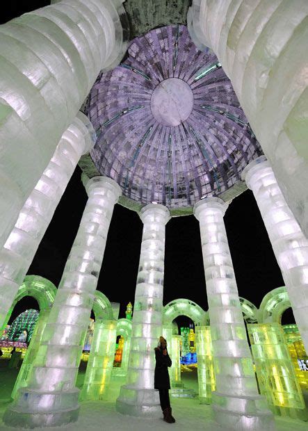 A Visitor Looks At One Of The Huge Structures At The 2013 Harbin