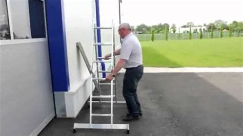 A Man Is Climbing Up The Side Of A Ladder