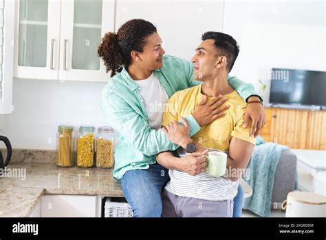 Biracial Man Embraces His Middle Eastern Partner In A Cozy Kitchen With Copy Space The Gay