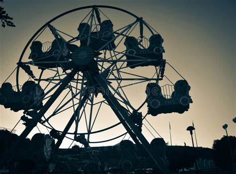 Close Up Of An Old Abandoned Rusty Metal Ferris Wheel Against Blue Sky