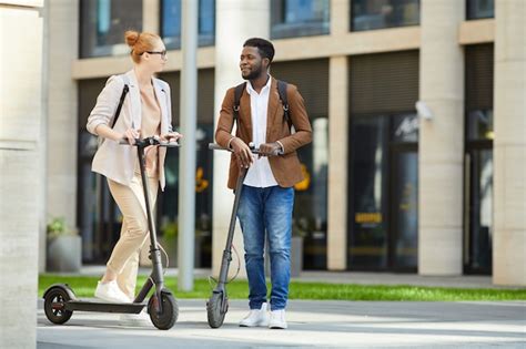 Premium Photo Couple Riding Electric Scooters In City