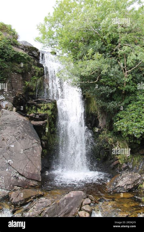 A High Waterfall Cascading Over a Hillside Rock Face Stock Photo - Alamy