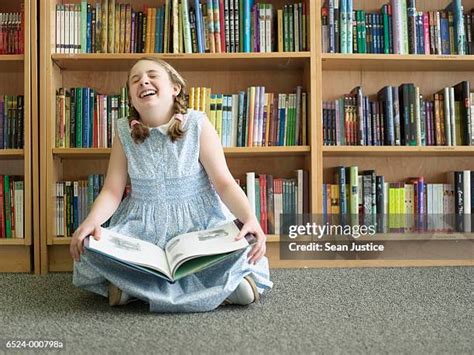 Girl Sitting On Floor Of Library With Book Photos And Premium High Res