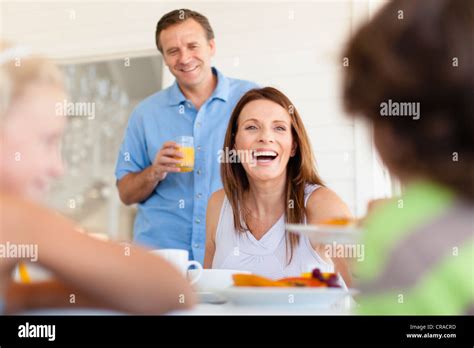 Family eating together at table Stock Photo - Alamy