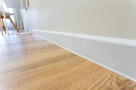 A detailed closeup photograph showcasing a modern wooden floor paired