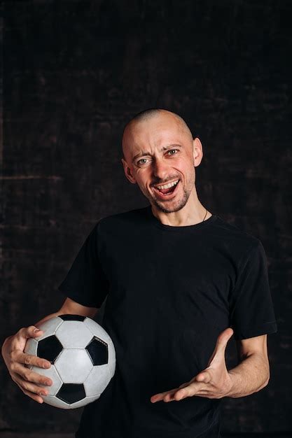 Premium Photo | Bald man showing soccer ball