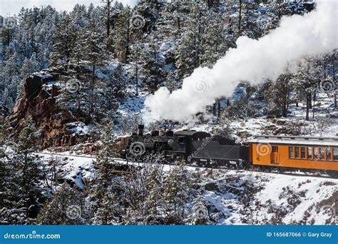 Vintage Steam Train Billowing Smoke As It Moves Through The Mountains