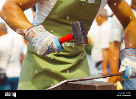 A Blacksmith Hammering A Hot Metal Rod To Shape It Stock Photo Alamy