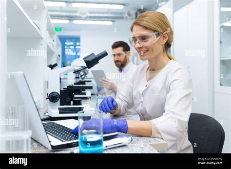 Mature Female Scientist In White Coat At Work Laboratory Assistant