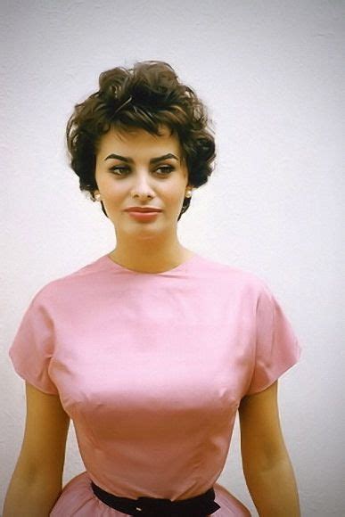 A Woman In A Pink Dress Poses For A Photo