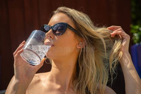 A Blonde Woman Is In A Swimming Pool Drinking A Fizzy Cocktail Stock Photo Image Of Drinking